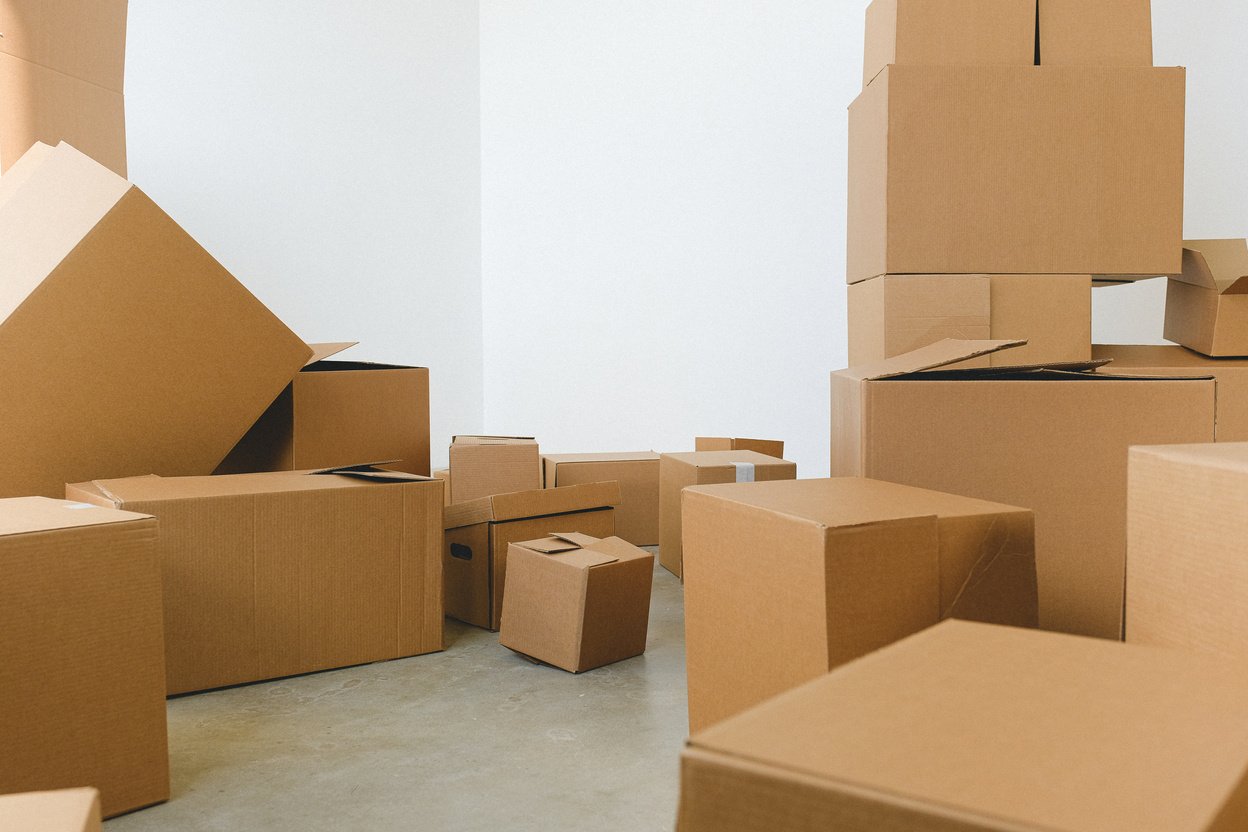 Pile of cardboard boxes scattered on floor during relocation